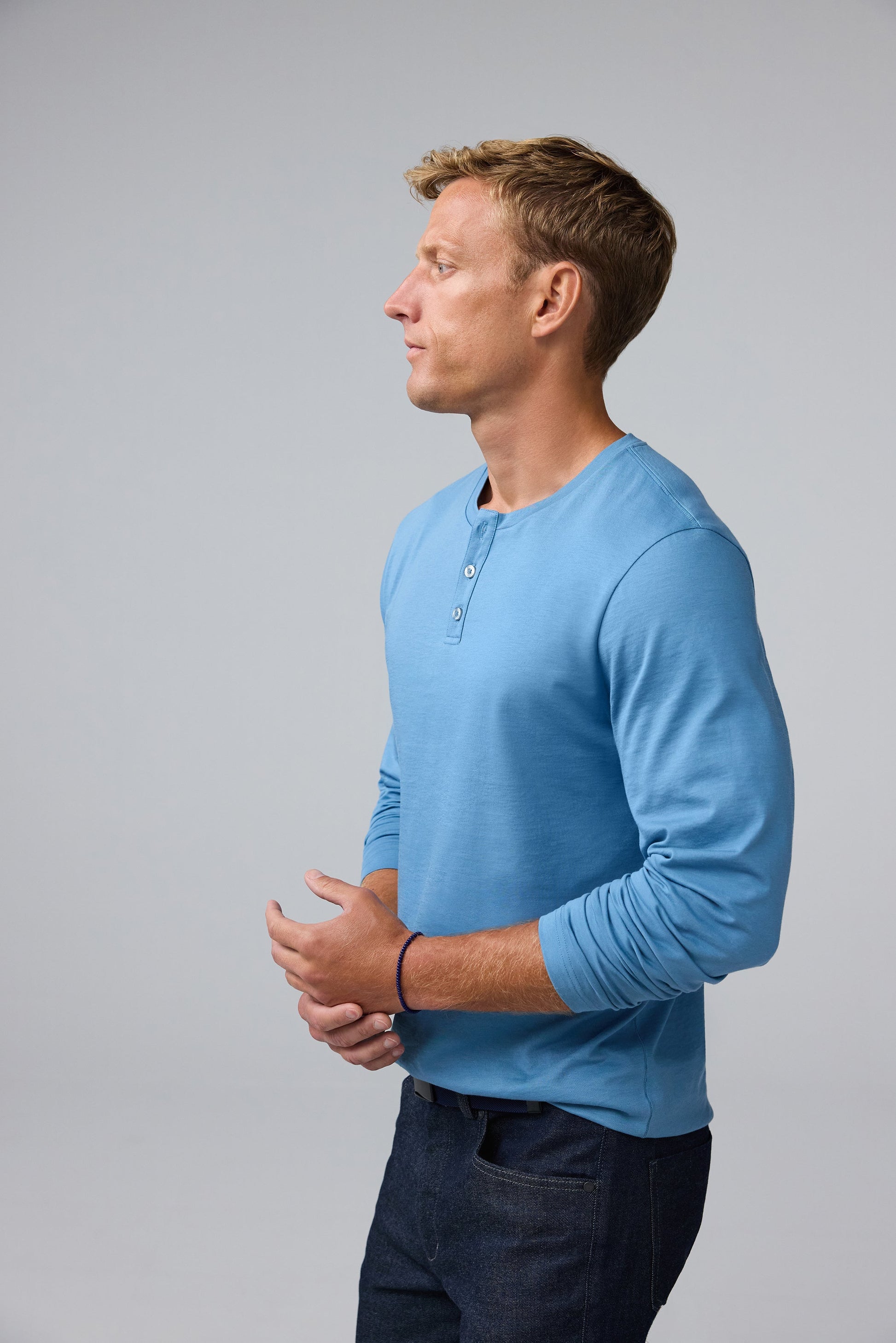 Side view of man wearing Pima Long Sleeve Henley in Blue Heaven