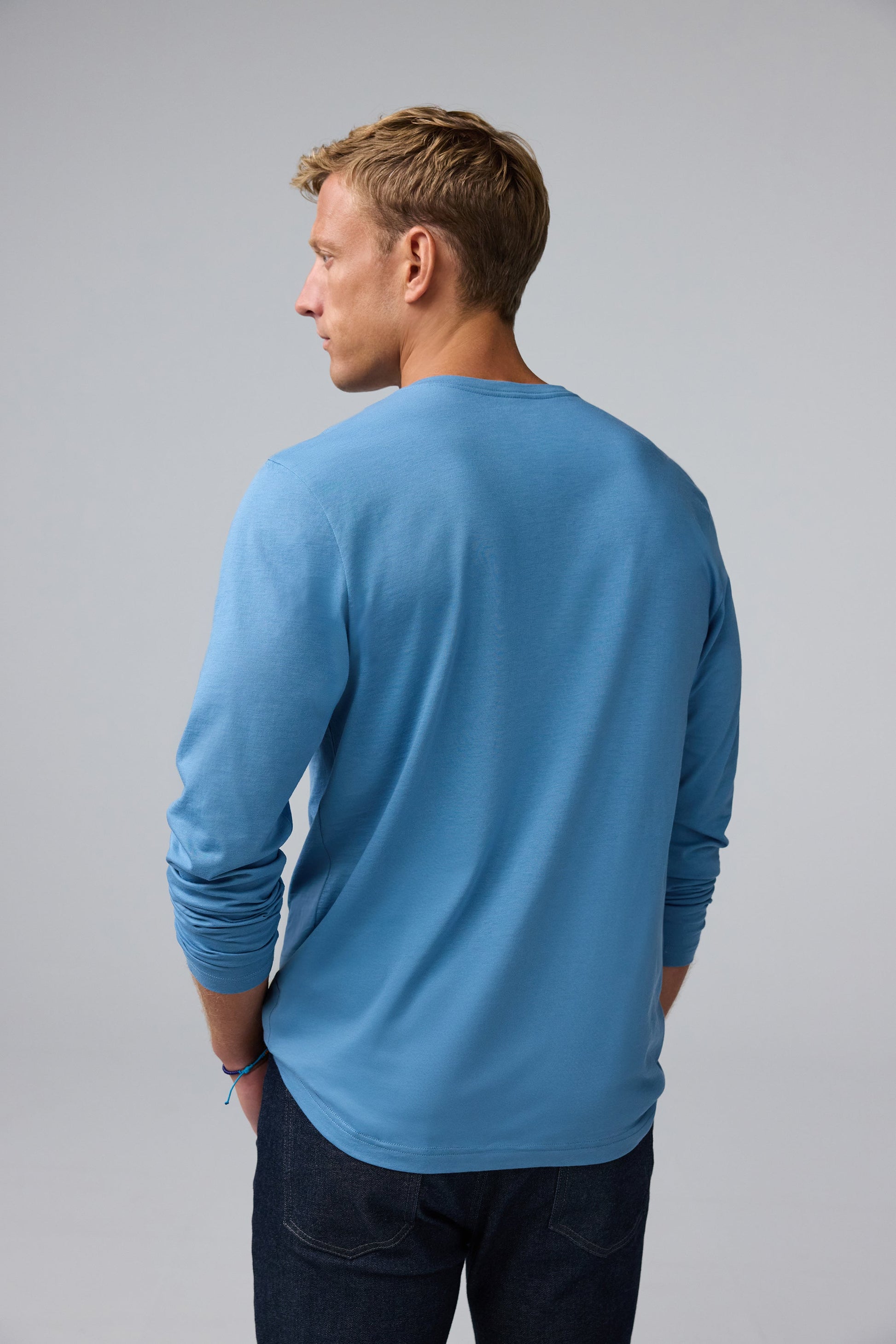 Back view of man wearing Pima Long Sleeve Henley in Blue Heaven