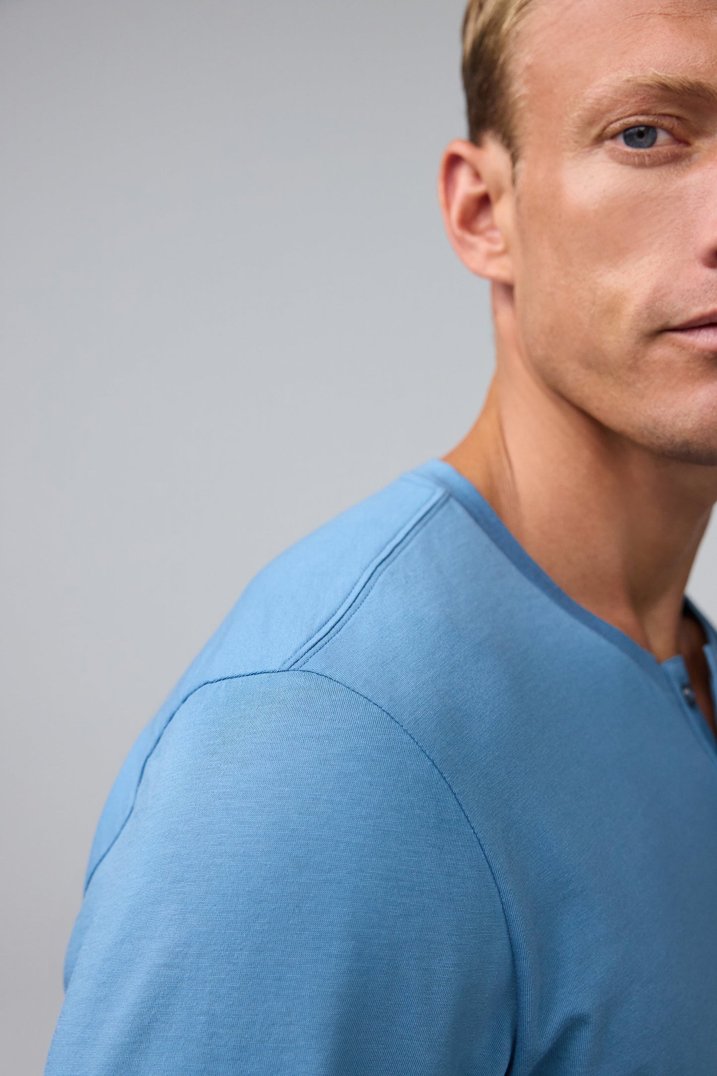 Detail shoulder view of man wearing Pima Long Sleeve Henley in Blue Heaven