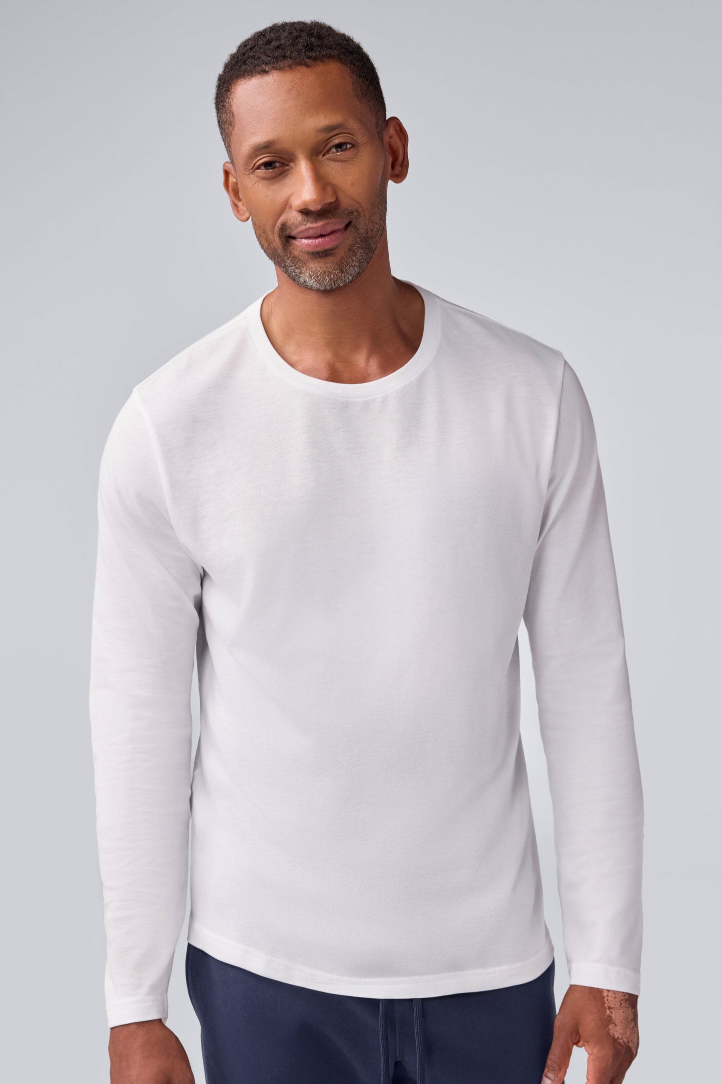 Front view of a man wearing Pima long sleeve T-shirt in Bright White