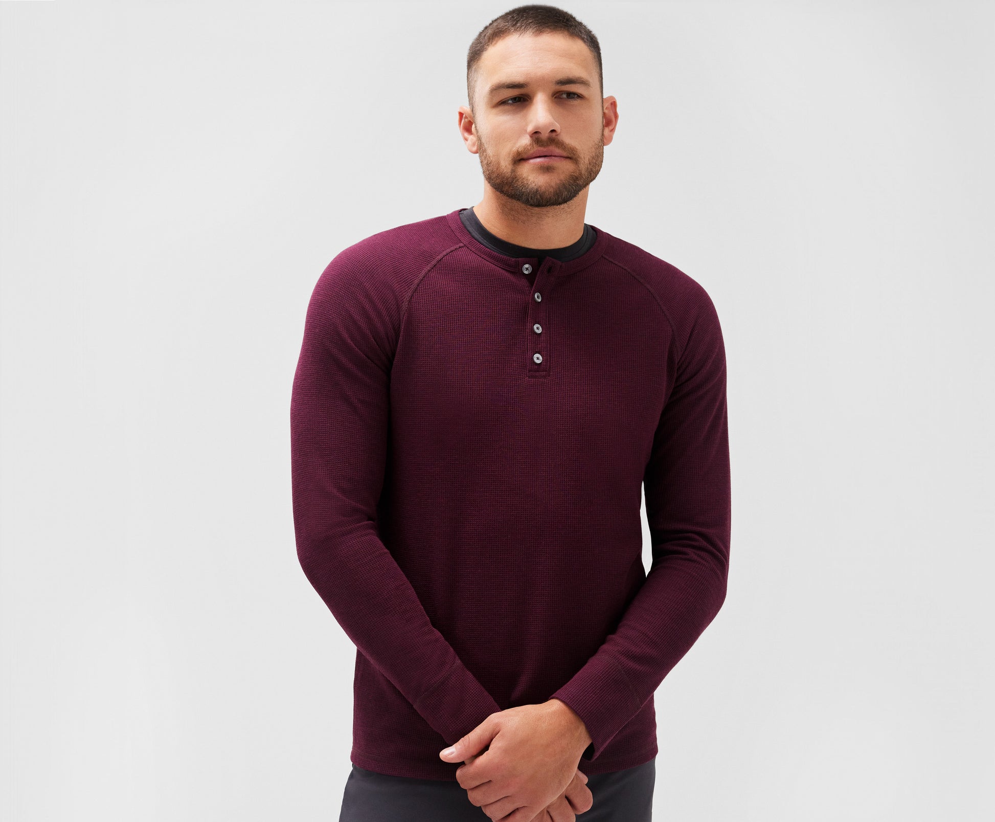 Front view of a man wearing WARMKNIT Waffle Henley in Lambrusco Heather