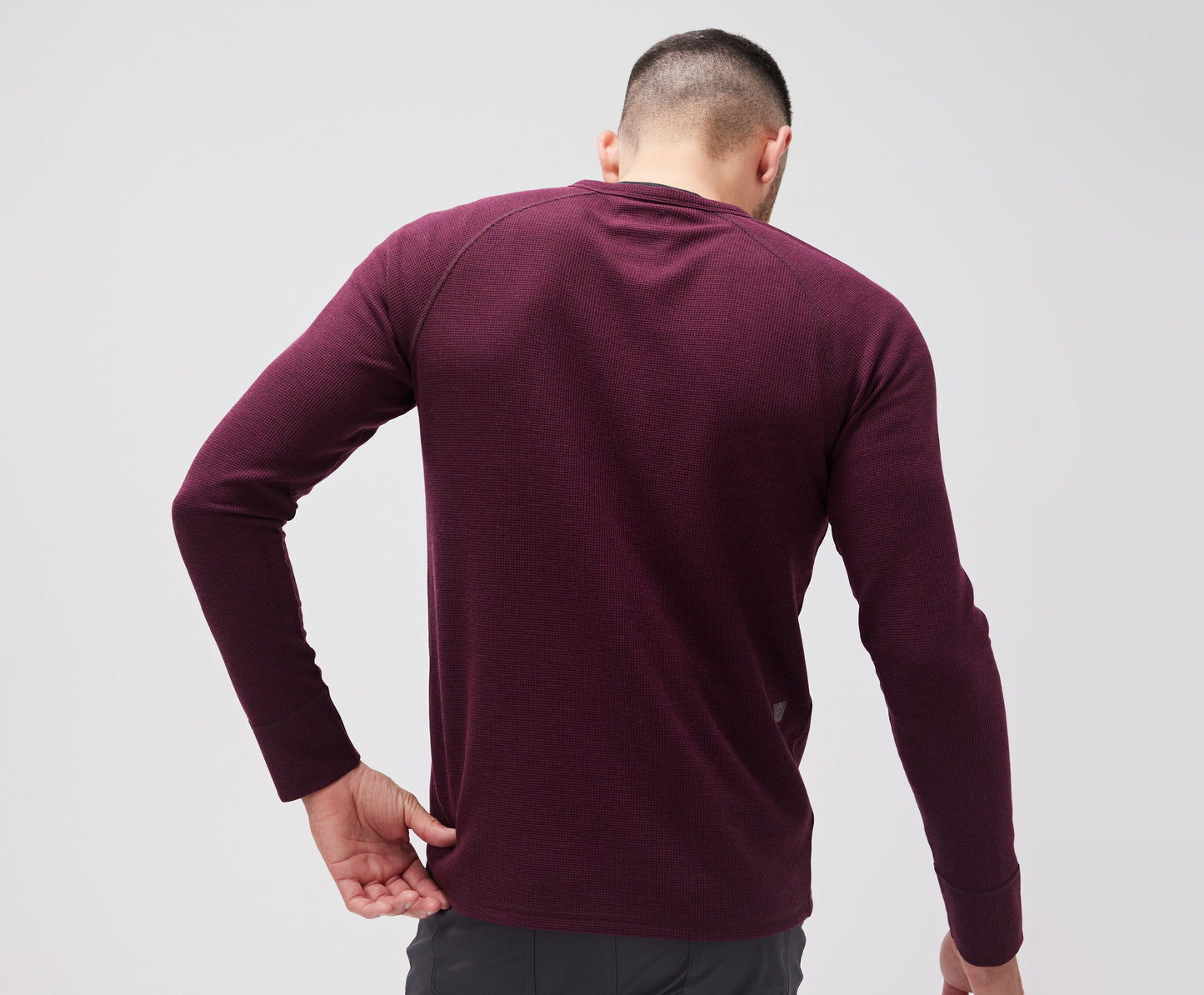Back view of a man wearing WARMKNIT Waffle Henley in Lambrusco Heather